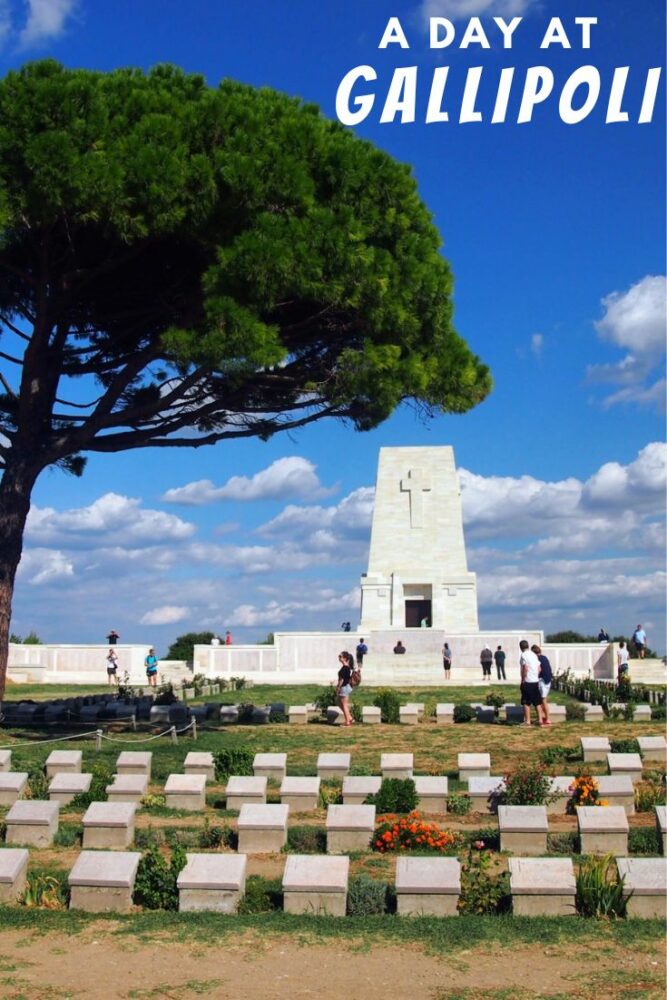 Text "A Day at Gallipoli" overlaid over a photo of rows of grave markers under a tree with a memorial in the background