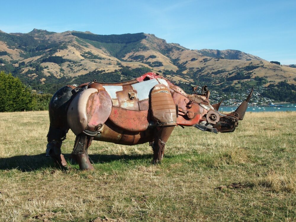 Large metal rhino sculpture on a hill in Banks Peninsula