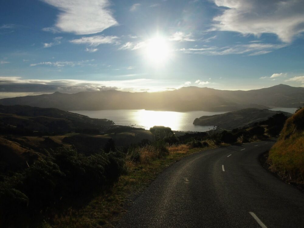 Sunset view taken from the side of the road overlooking a harbour on Banks Peninsula