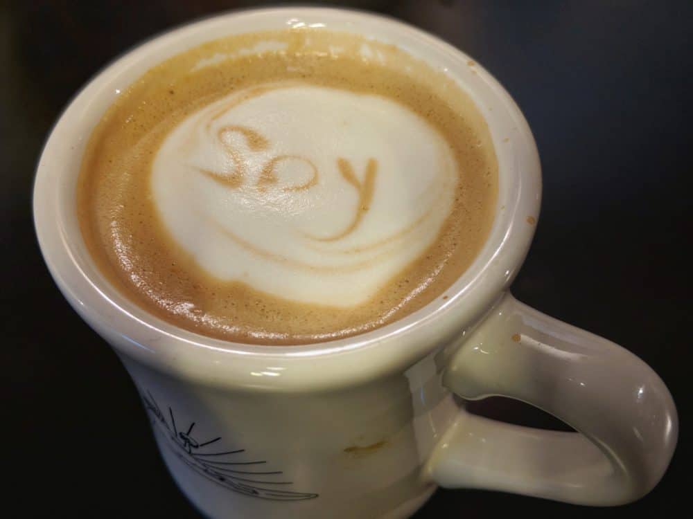 Coffee with soy milk in Japan, and the word 'soy' written in the latte art