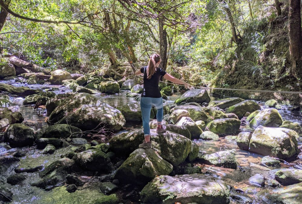 Lauren rock-hopping near Korokoro Falls