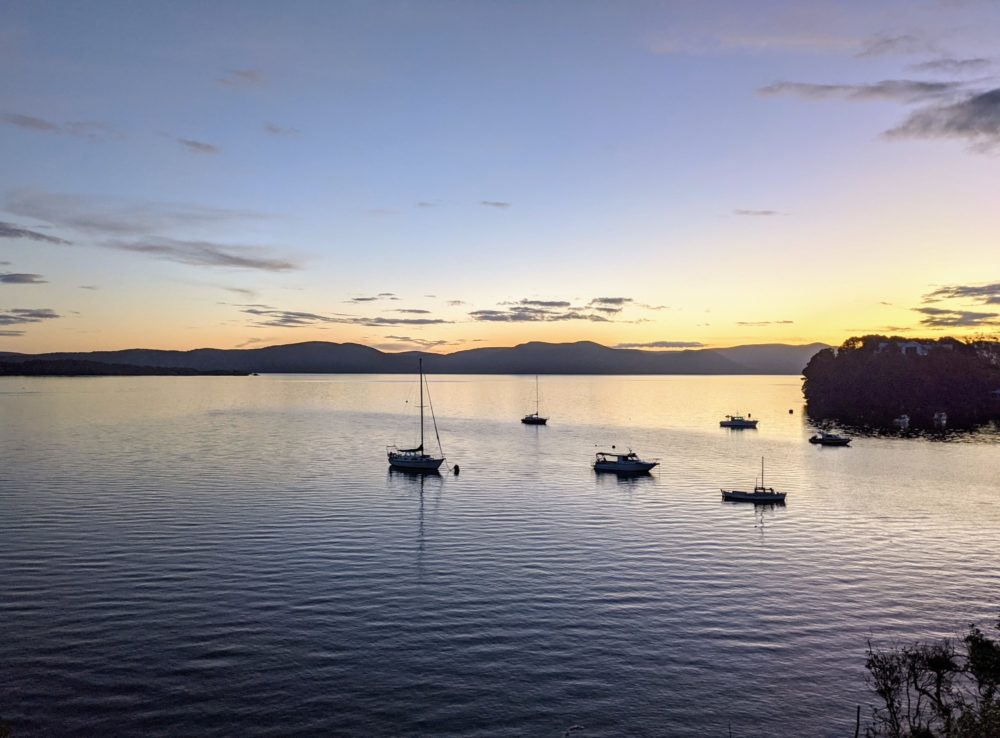 Boats in the harbour at sunset outside Oban on Stewart Island, New Zealand