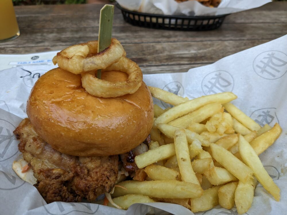 Chicken burger and fries on paper wrapping