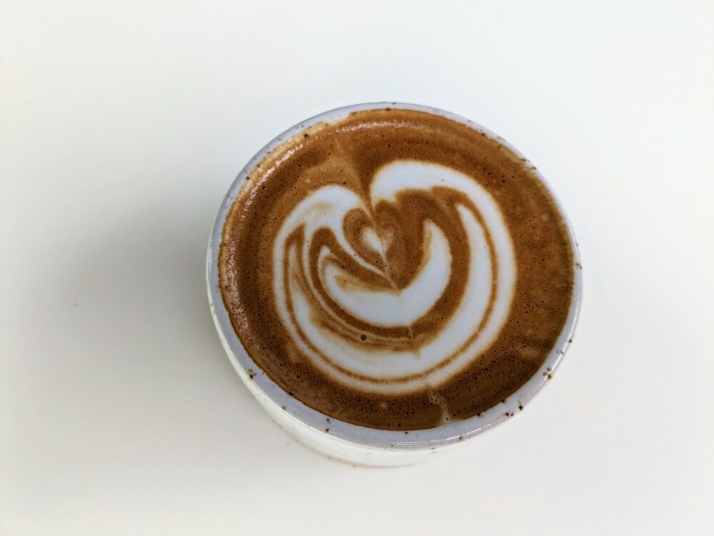 Aerial view of coffee with latte art on white background at Tab x Tab, Notting Hill