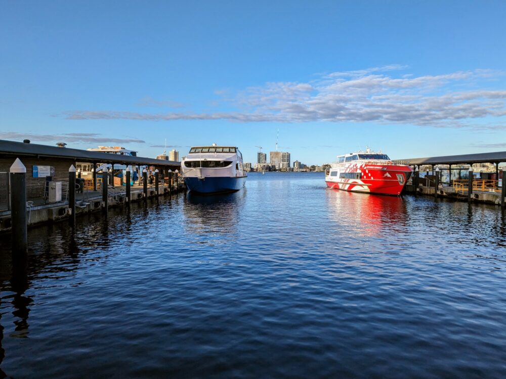 Two ferries berthed alongside each other at city jetties