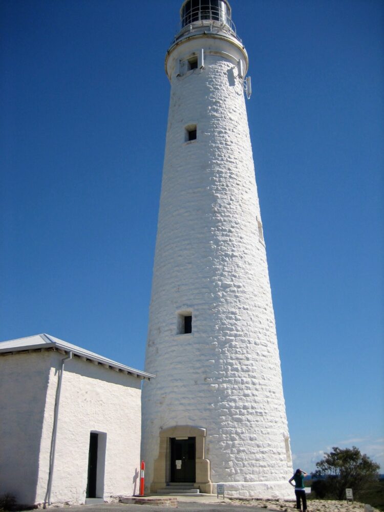 White lighthouse with a smaller white building alongside