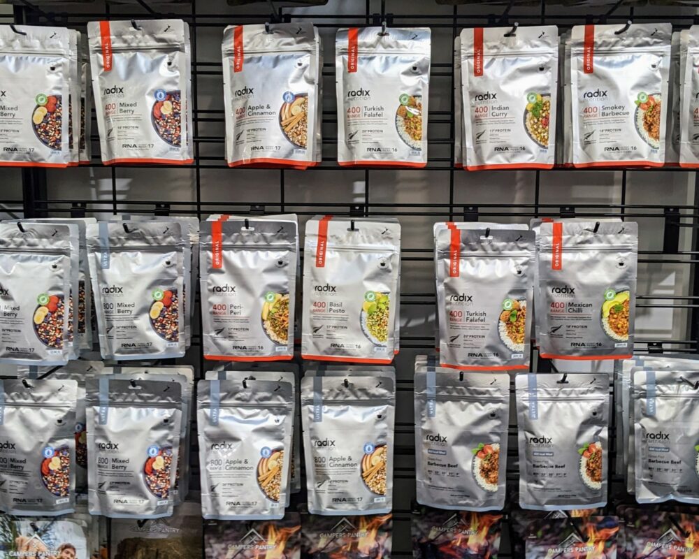 Packets of dehydrated/freeze-dried camping food on a stand in a store